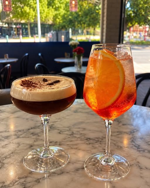 An espresso martini and an Aperol spritz on the bar